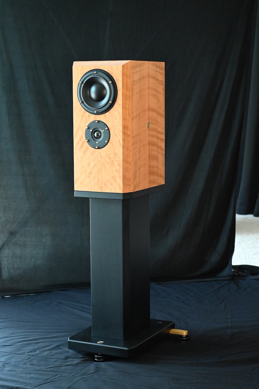 Bravo Acoustics Aria loudspeaker, front and side view, natural wood cabinet